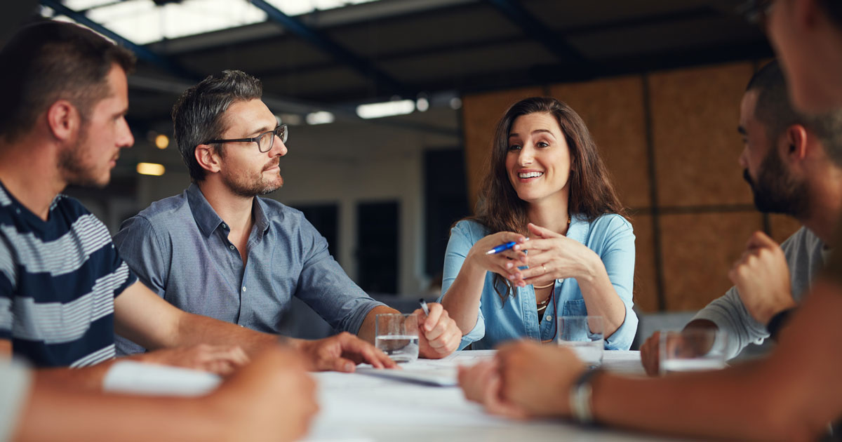Shot of a group of coworkers having a meeting in an open plan office