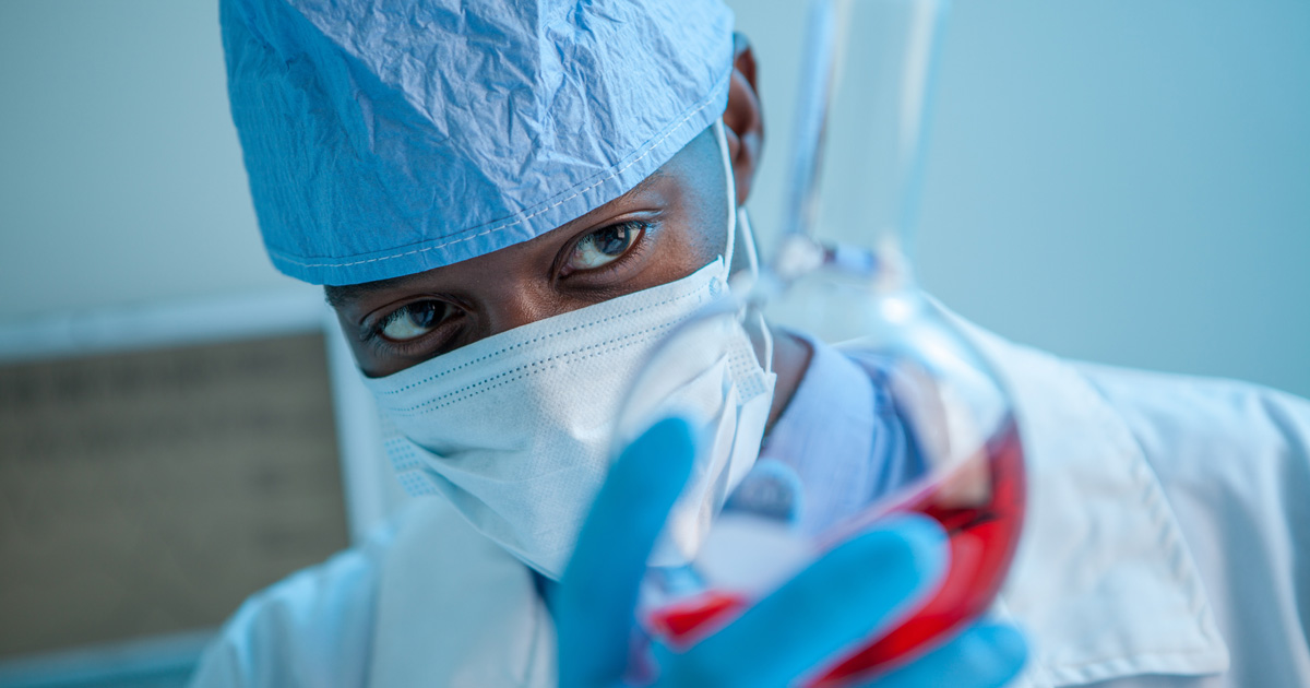 A doctor and researcher works on a vaccine.