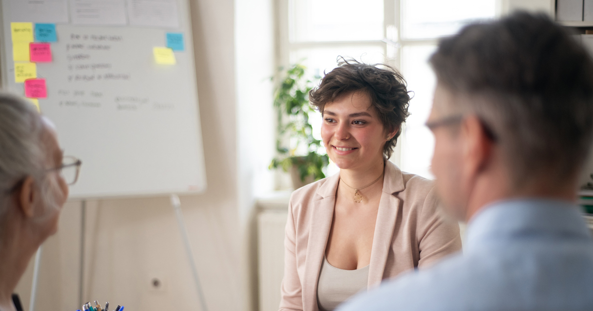 A young woman talking at a job interview.