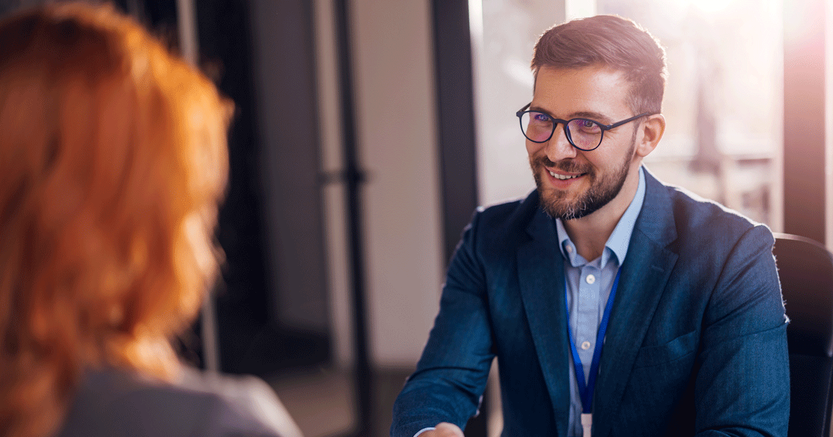 Happy bank manager shaking hands with a client after successful agreement in the office