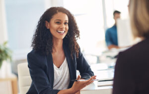 Shot of two young women having a conversation in a modern office