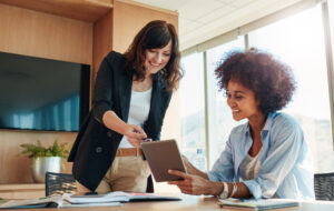 Business partners using touchscreen computer for project discussion