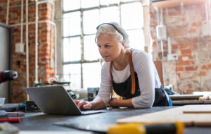 Confident senior woman working in workshop