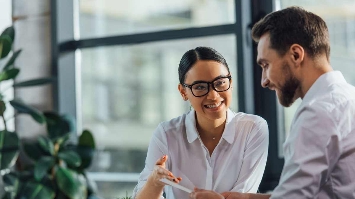 female asian translator working working with smiling businesswoman