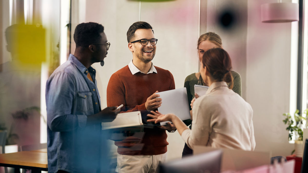 Happy multiracial business team has fun while talking on meeting in office.
