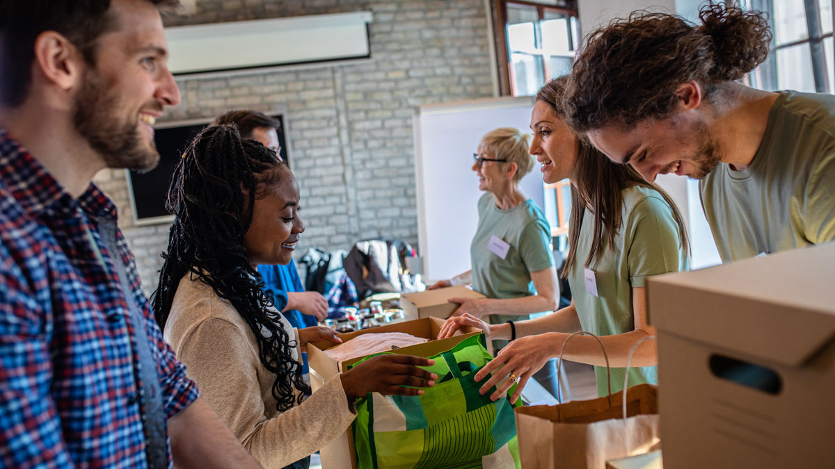 Group of volunteers with working in community charity donation center