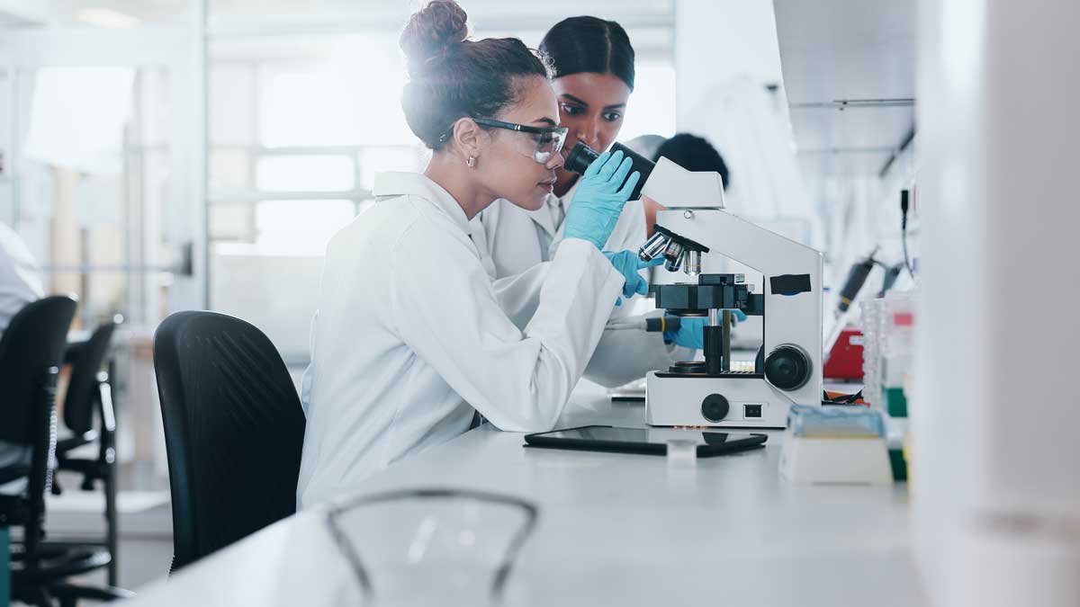 Scientist, microscope and woman for research, analysis and samples for medical testing. Biotechnology, life expansion drug study in laboratory, innovation and dna specialist people for science