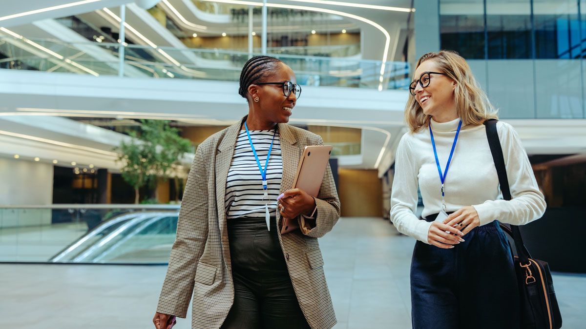 Successful young accountants walking and talking in a modern office environment
