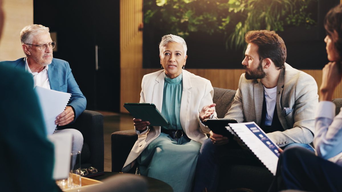 Business people, meeting and planning in workplace, conversation and brainstorming for creative project. Group, employees and leader in office, teamwork and feedback for ideas, talking and proposal