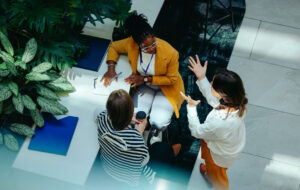 Overhead view of female colleagues discussing in modern office