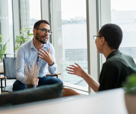 Business people having meeting in office lobby