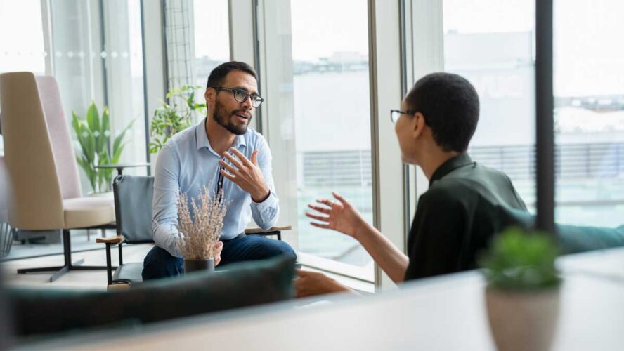 Business people having meeting in office lobby