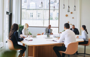 Smiling group of diverse businesspeople having a boardroom meeting together