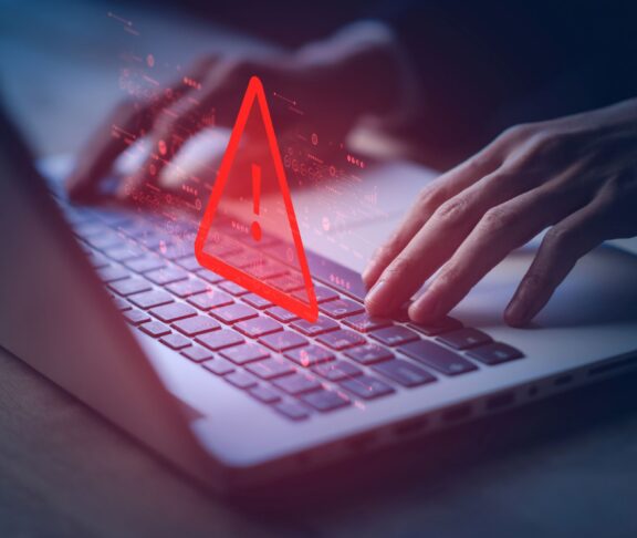 System hacked warning alert on notebook (Laptop). Cyber attack on computer network, Virus, Spyware, Malware or Malicious software. Cyber security and cybercrime. Compromised information internet