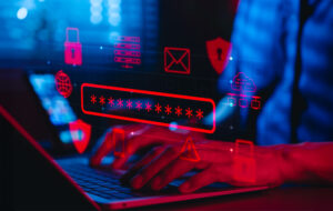 Osoba wpisująca hasło na laptopie, otoczona cyfrowymi ikonami bezpieczeństwa w cyberprzestrzeń