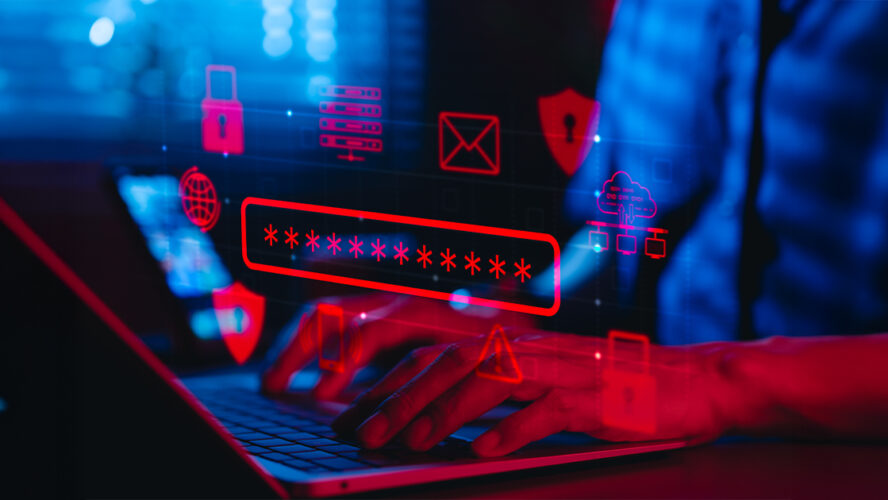Osoba wpisująca hasło na laptopie, otoczona cyfrowymi ikonami bezpieczeństwa w cyberprzestrzeń