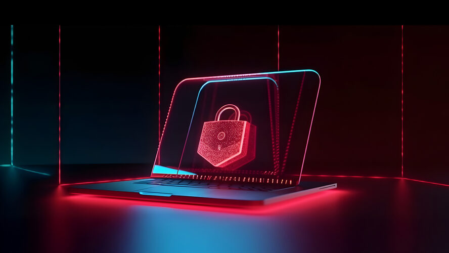 Laptop z hologramem kłódki symbolizujący ochronę przed atakami ransomware