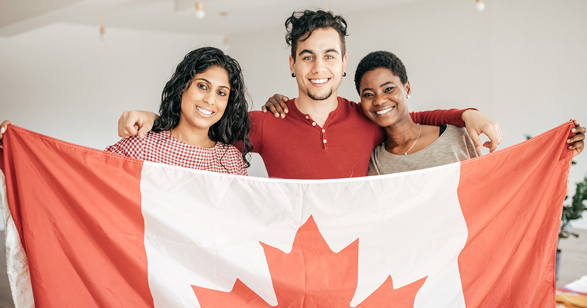 Three new Canadians holding a flag