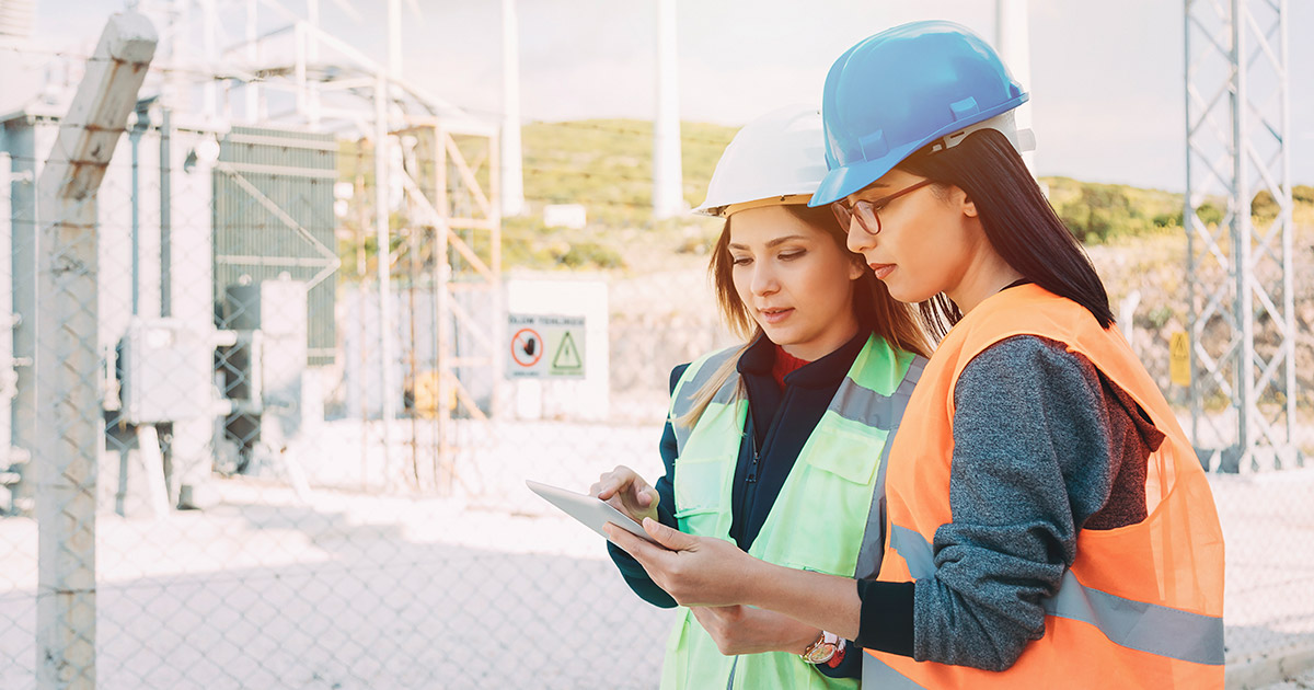 Two female electricians looking at paperwork
