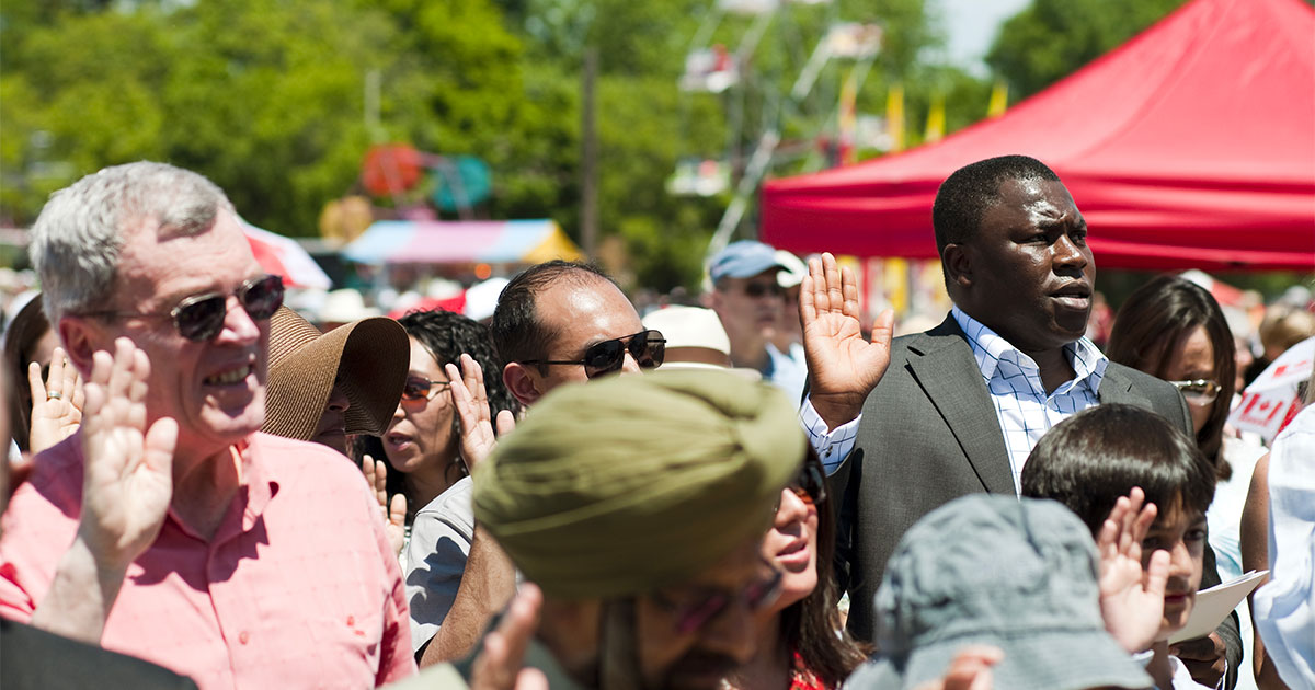 New Canadian Citizens are sworn in during a Canada Day new citizenship ceremony at Milton, Ontario fairgrounds.