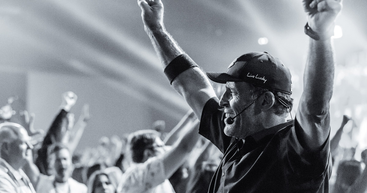 Tony Robbins speaking to an excited crowd