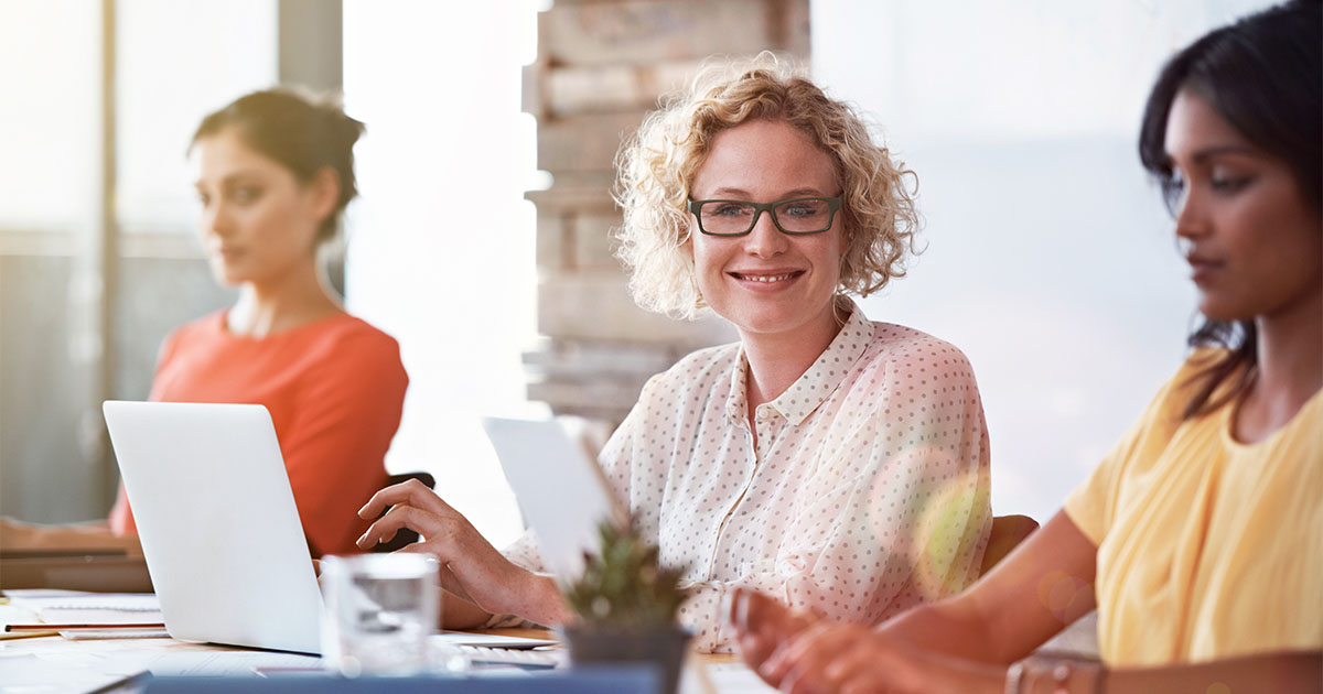women of different races smiling working