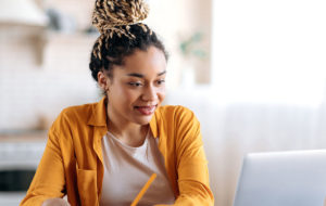 black woman smiling at computer screen