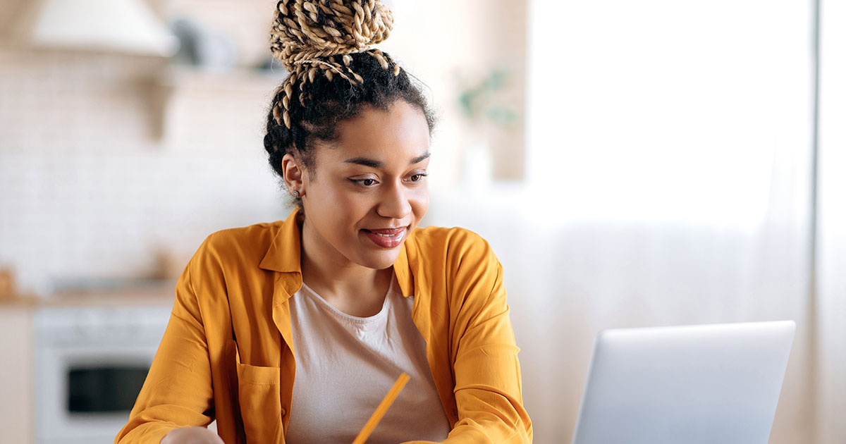 black woman smiling at computer screen