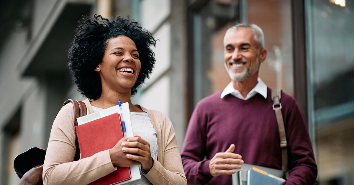 black woman and brown man smiling ucalgary