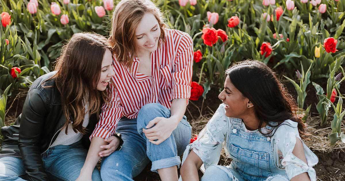 three girls smiling and laughing