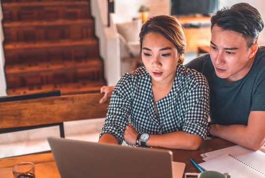 Couple in front of a computer