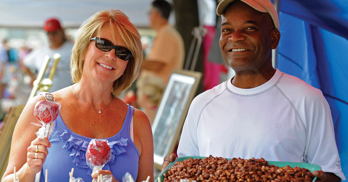 Two smiling people at a fair