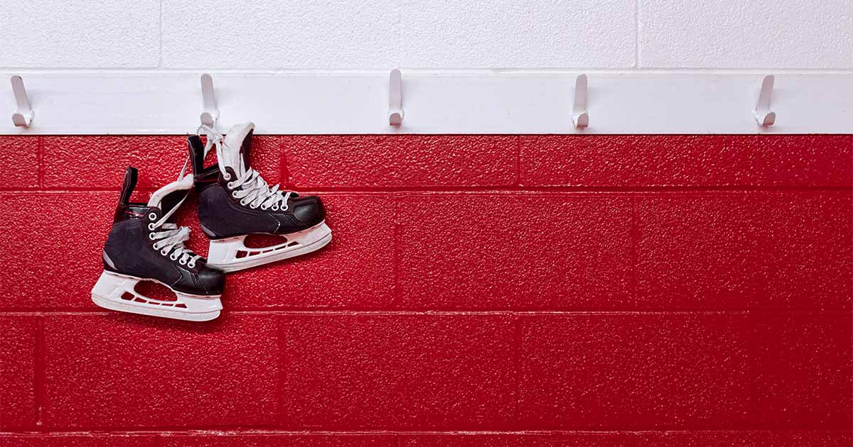 hockey skates over red wall