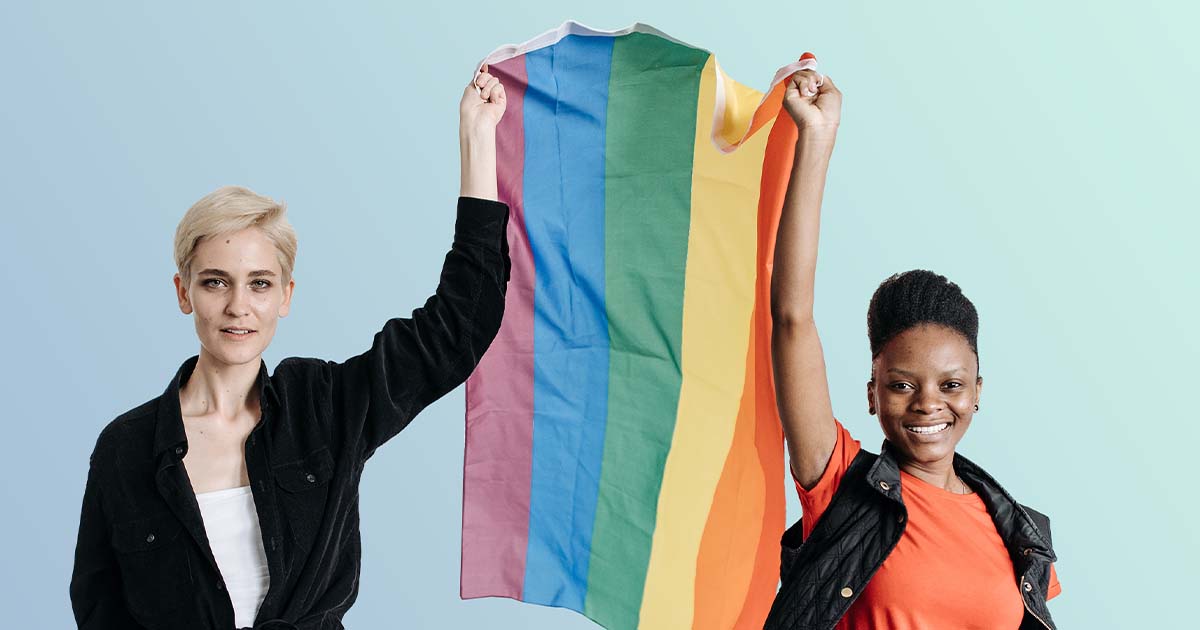 two people holding pride flag