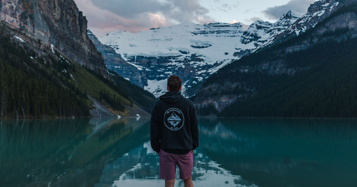 man standing in front of lake louise