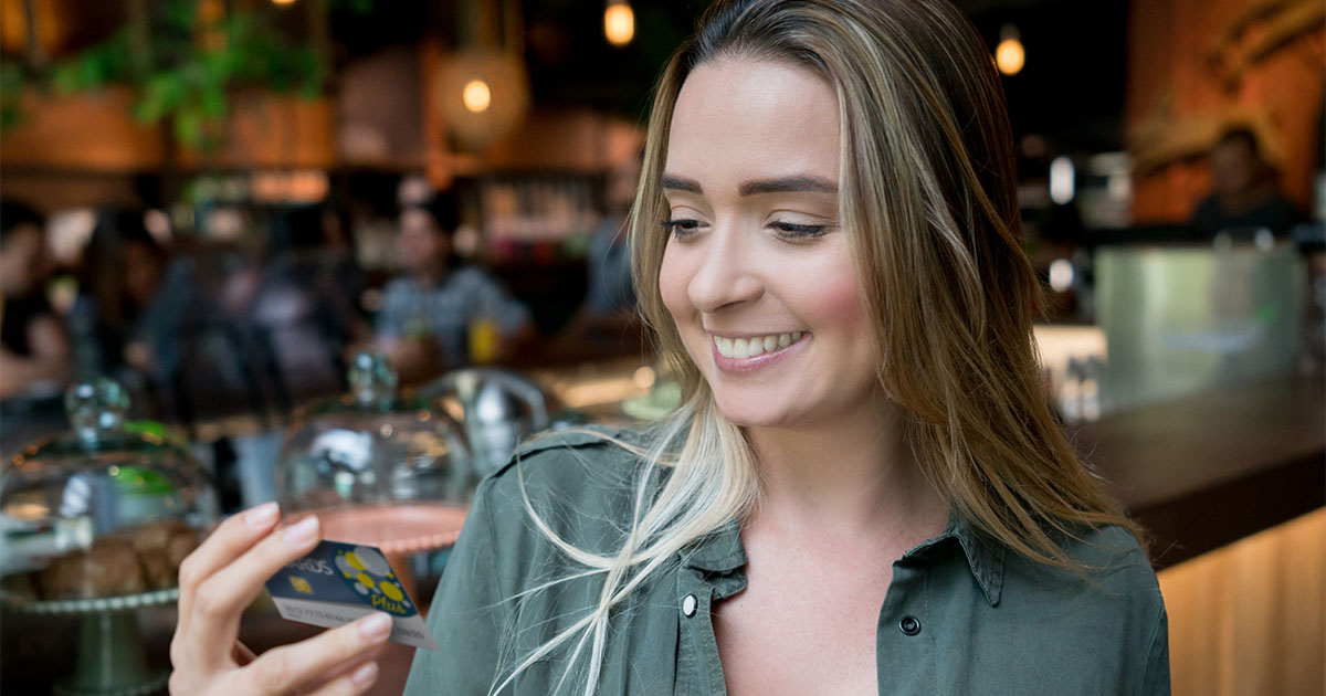 young woman smiling at rewards card