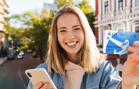woman holding air miles rewards card