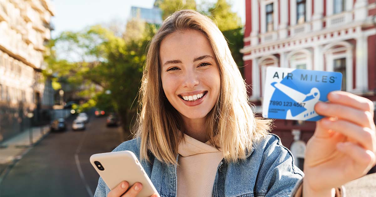 woman holding air miles rewards card