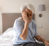 Senior-Frau mit Kopfschmerzen