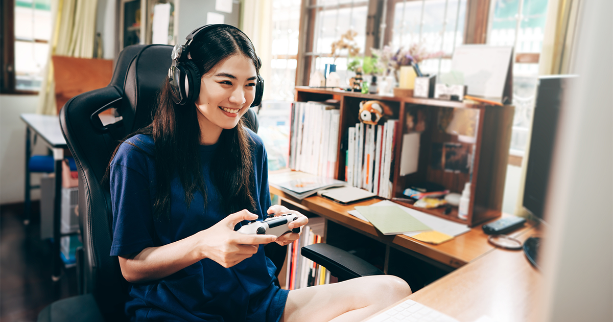 Young adult woman hand holding a joy controller wear headset and play game.