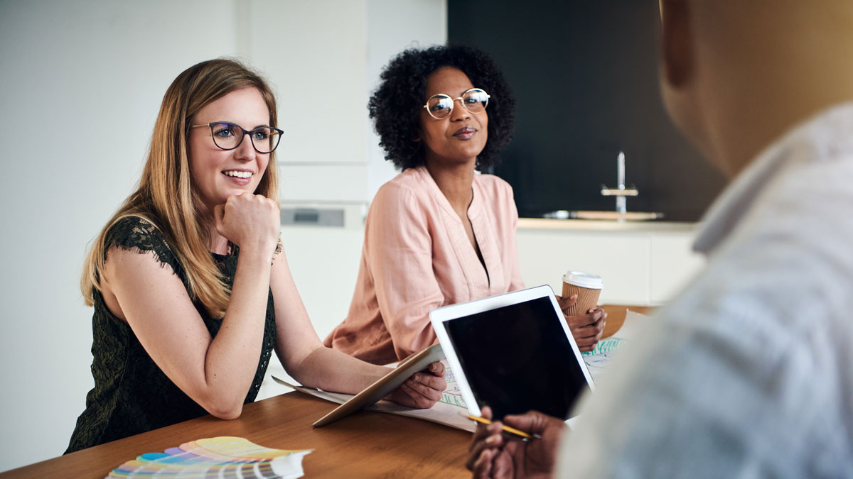 Diverse businesswomen having a meeting with coworkers in a boardroom