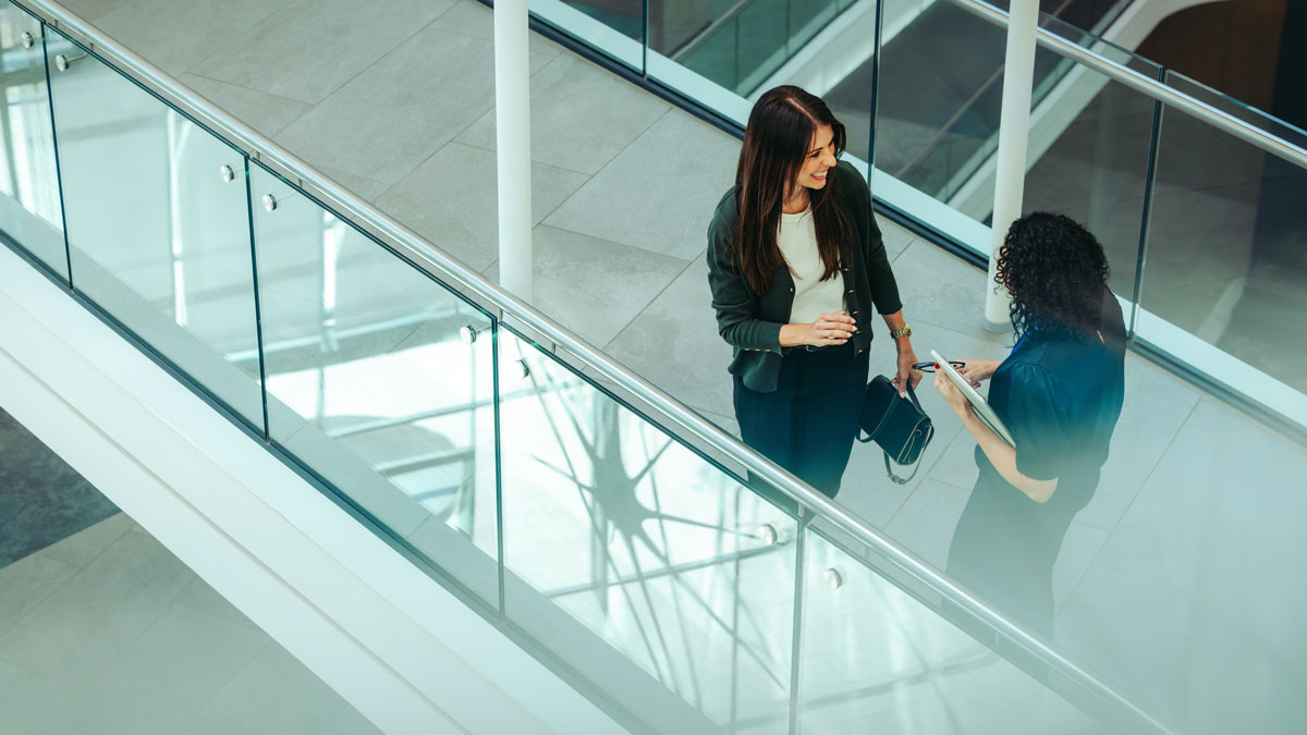 Coworkers chatting in a modern office environment