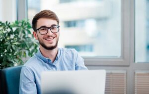Young businessman in office working on laptop