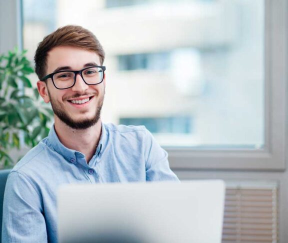 Young businessman in office working on laptop