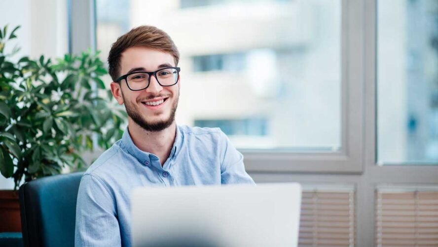 Young businessman in office working on laptop