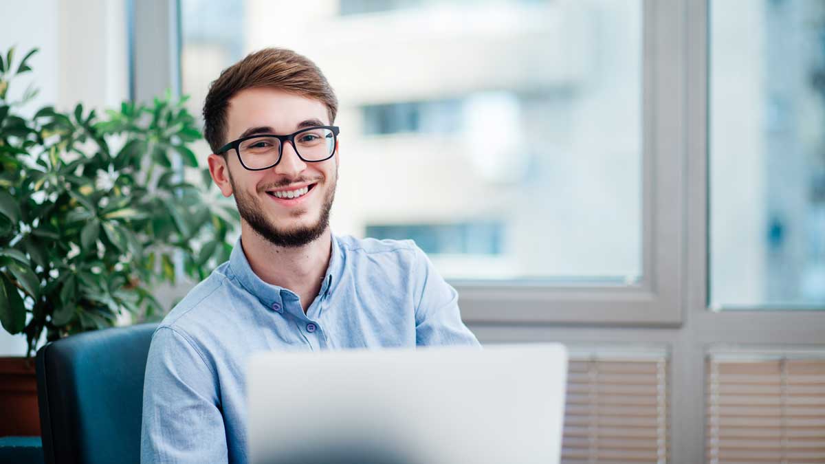 Young businessman in office working on laptop