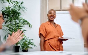 Shes delivered a memorable talk. Shot of a young businesswoman receiving applause from her colleagues during a meeting in an office.