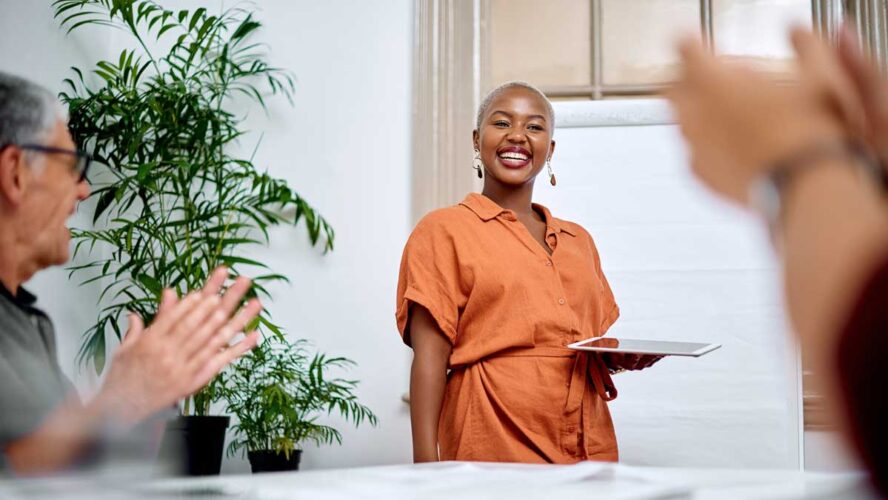 Shes delivered a memorable talk. Shot of a young businesswoman receiving applause from her colleagues during a meeting in an office.