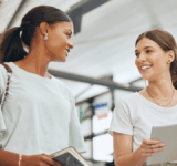 University, communication and students talking about education with tablet and notebook on campus together. Diversity at college with friends speaking while walking so study for project with tech