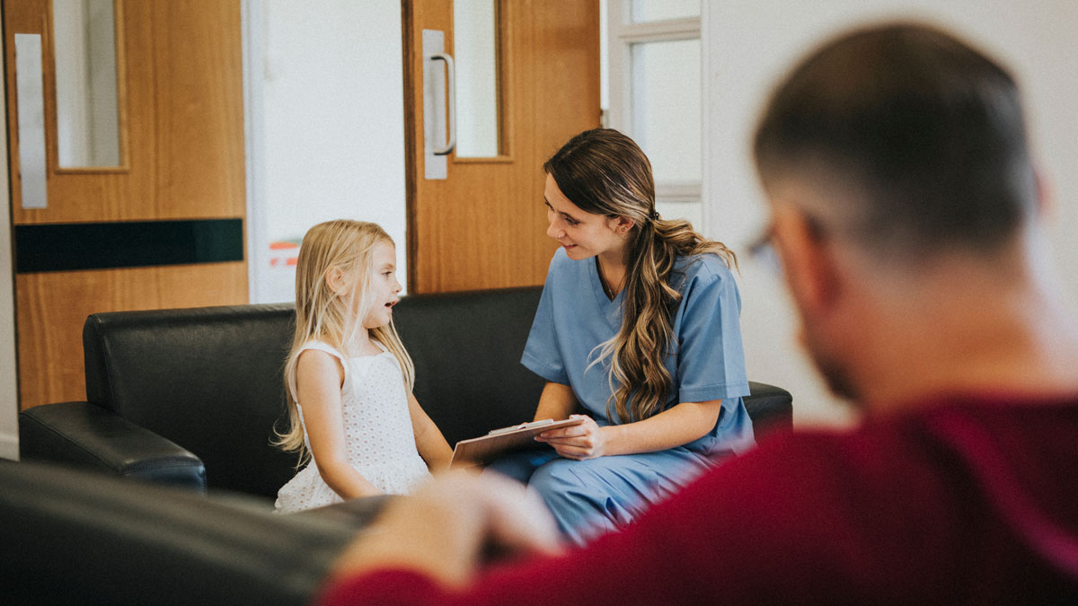 Young girl speaking to a female nurse
